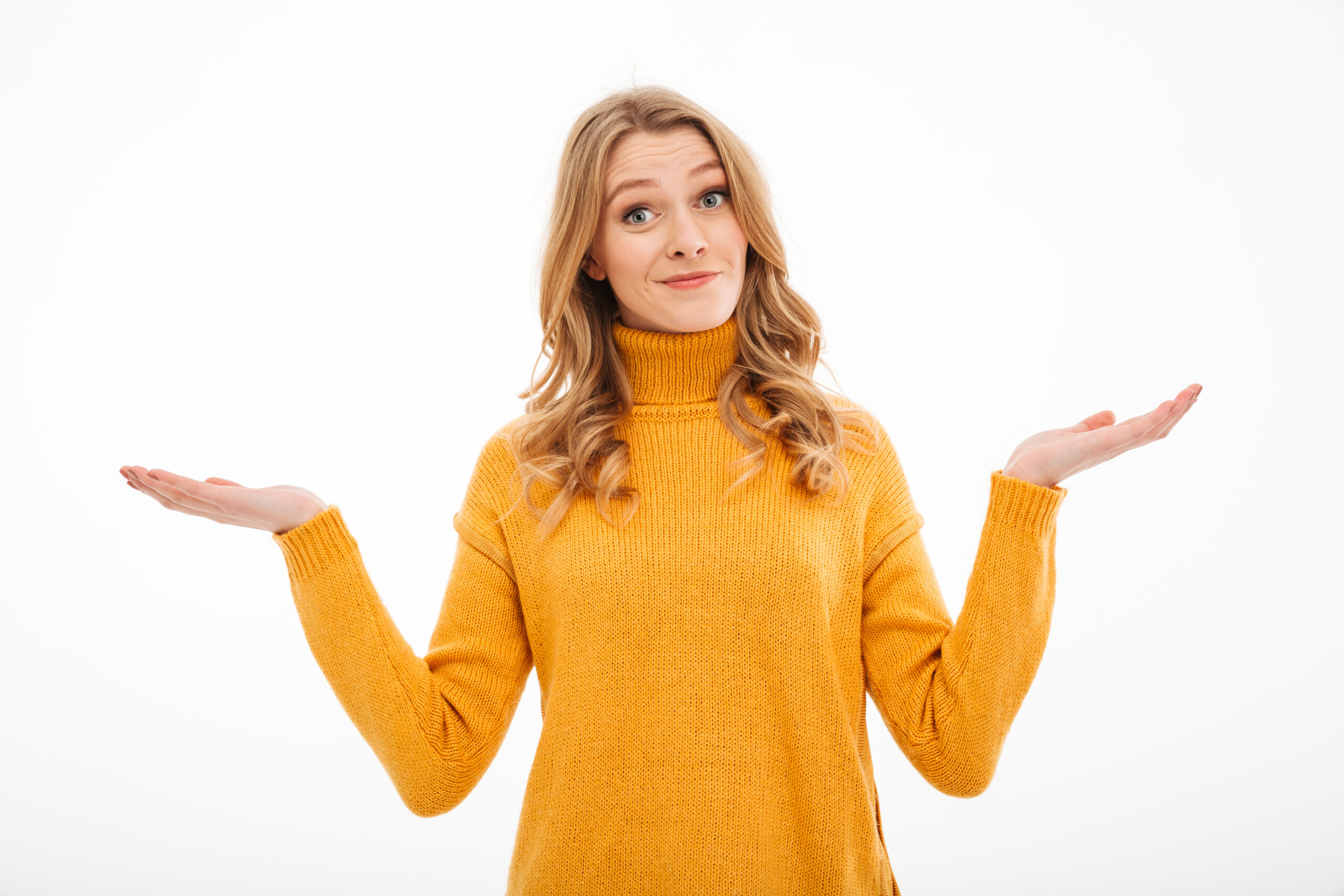 Photo of confused young lady standing isolated over white background. Looking camera.